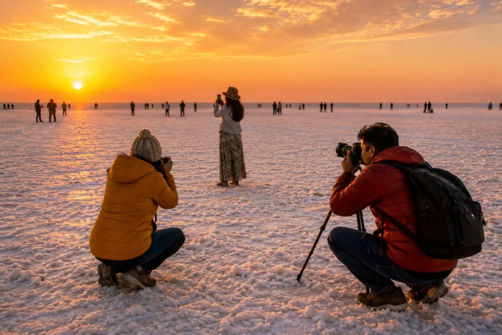 Travelers capturing sunset photographs at the White Desert of Kutch during golden hour.